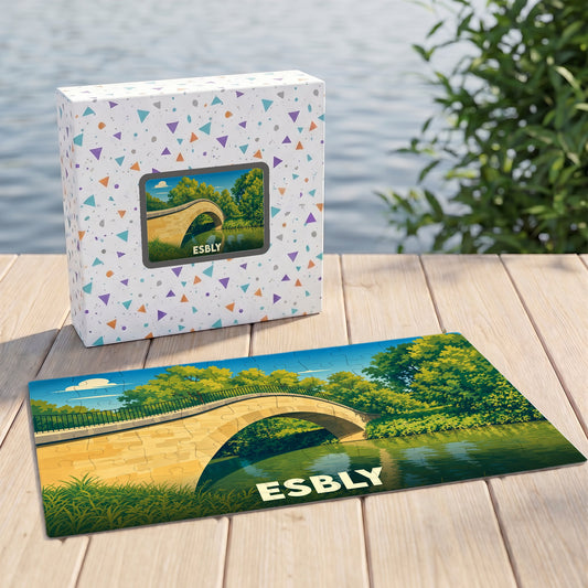Puzzle souvenir de la ville d'Esbly illustrant un pont de pierre au-dessus d'une rivière calme.