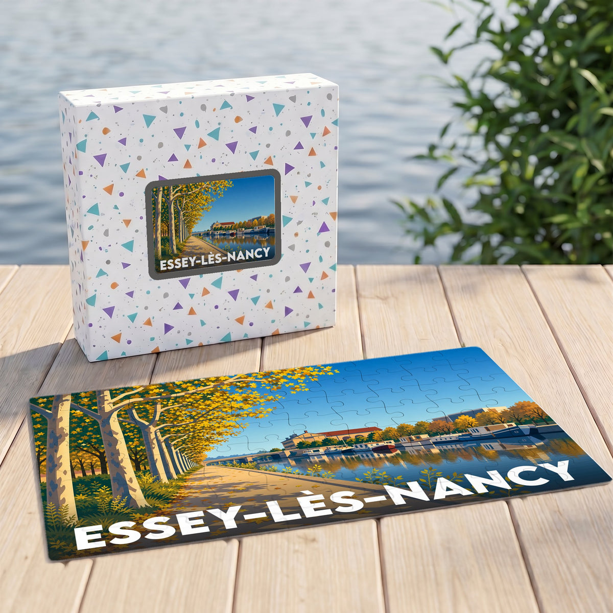 Puzzle souvenir de la ville d'Essey-lès-Nancy avec une illustration stylisée d'un canal bordé d'arbres en automne.