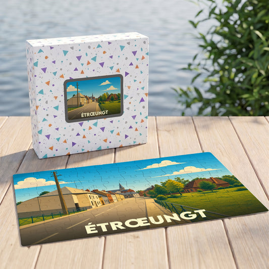 Puzzle souvenir de la ville d'Étrœungt avec une illustration stylisée d'un paysage urbain.