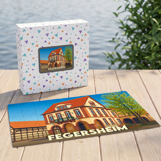 Puzzle souvenir de la ville de Fegersheim avec une illustration stylisée d'un bâtiment alsacien typique.