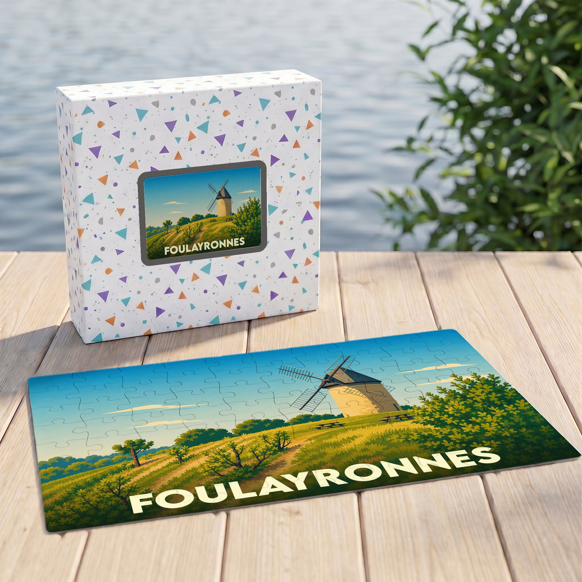 Puzzle souvenir de la ville de Foulayronnes illustré d'un moulin à vent dans un paysage vallonné.