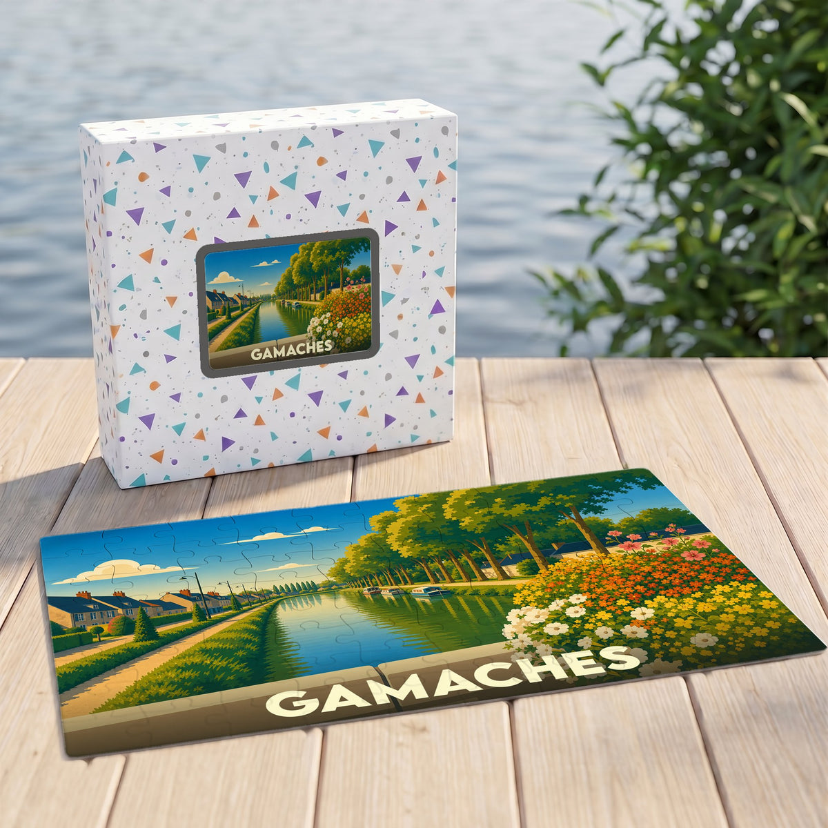 Puzzle souvenir de la ville de Gamaches avec une illustration colorée d'un canal bordé de fleurs.