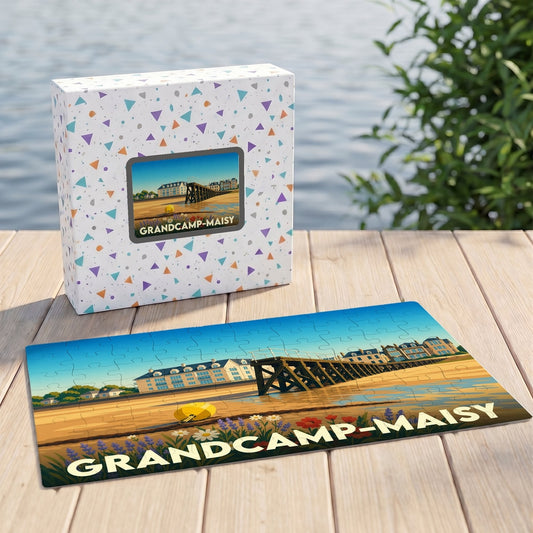 Puzzle souvenir de la ville de Grandcamp-Maisy avec une illustration de son front de mer sur sa boîte assortie.