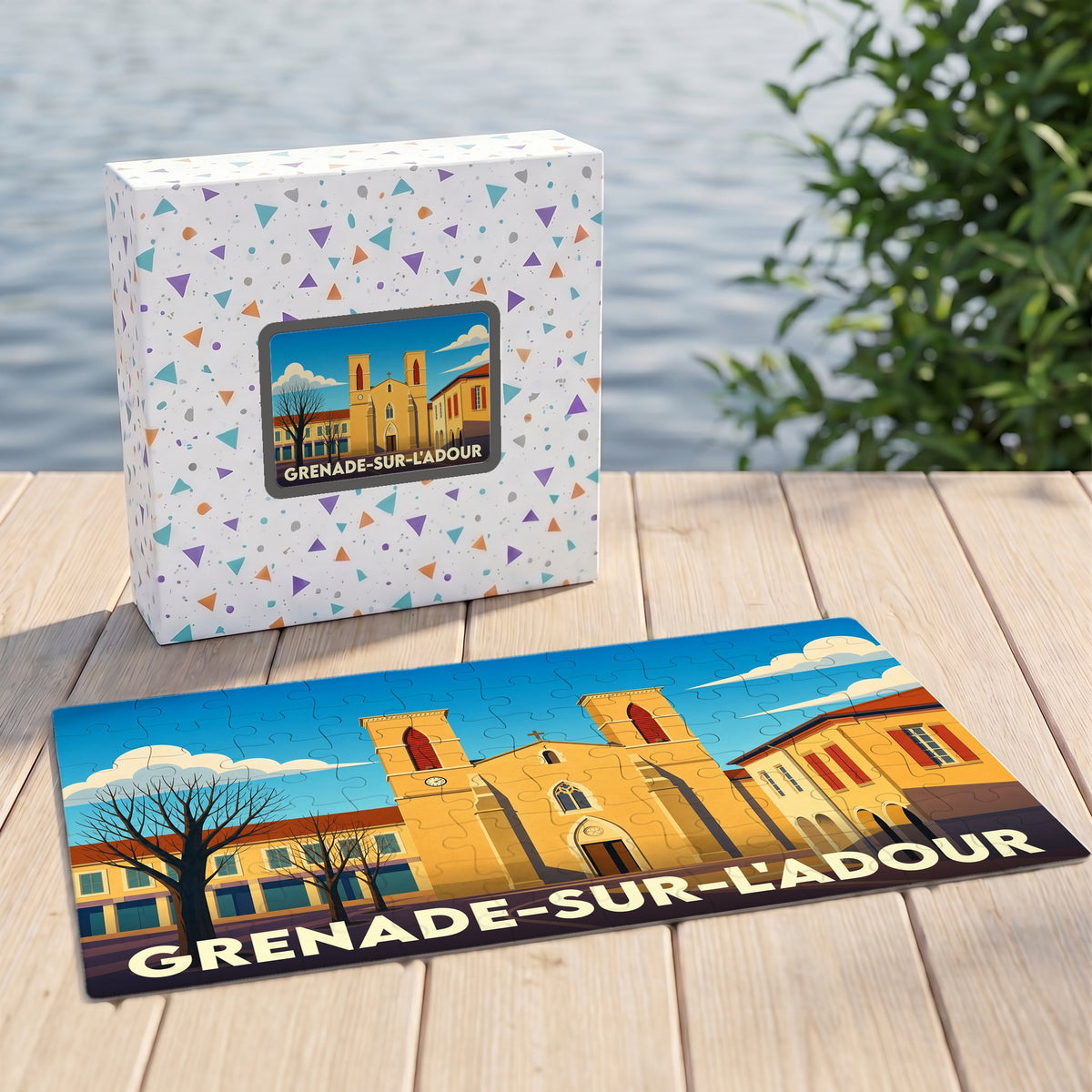 Puzzle souvenir de la ville de Grenade-sur-l'Adour avec une illustration stylisée de son église et de sa place.