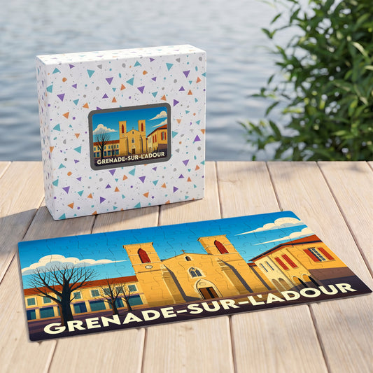 Puzzle souvenir de la ville de Grenade-sur-l'Adour avec une illustration stylisée de son église et de sa place.