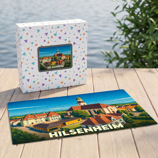 Puzzle souvenir de la ville de Hilsenheim avec une illustration stylisée et sa boîte assortie.