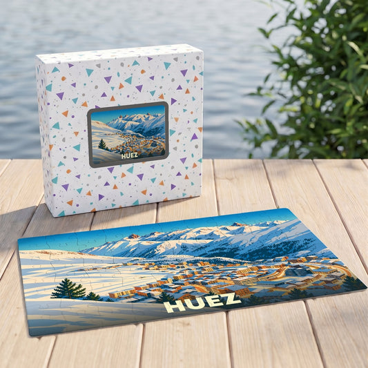 Puzzle souvenir de la ville de Huez illustré d'un paysage montagneux enneigé.