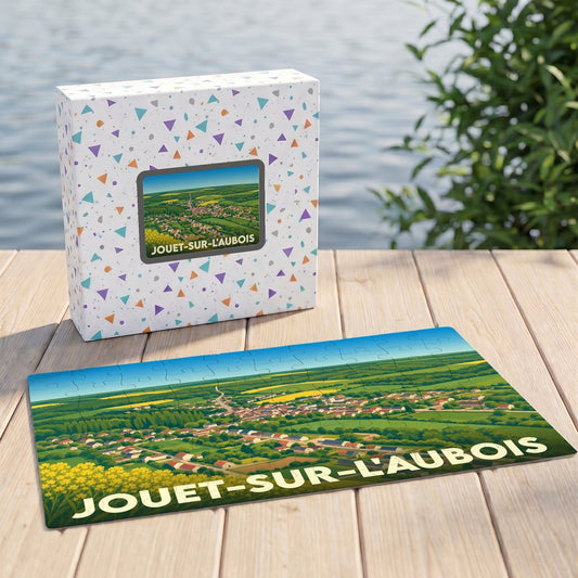 Puzzle souvenir de la ville de Jouet-sur-l'Aubois avec une illustration paysagère stylisée.