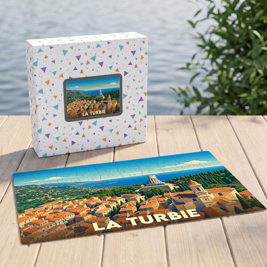 Puzzle souvenir de la ville de La Turbie avec une illustration stylisée d'un panorama côtier.