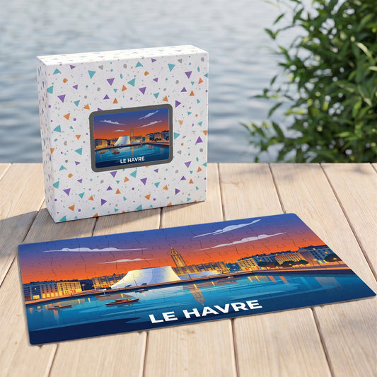 Puzzle souvenir de la ville du Havre avec une illustration stylisée représentant le port au coucher du soleil.