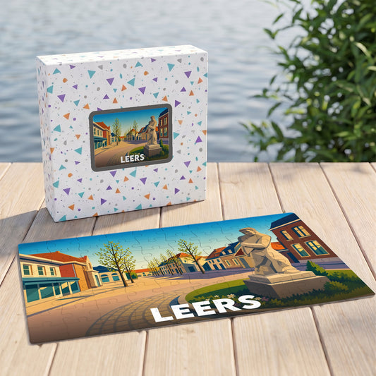 Puzzle souvenir de la ville de Leers illustrant une place avec une statue stylisée.