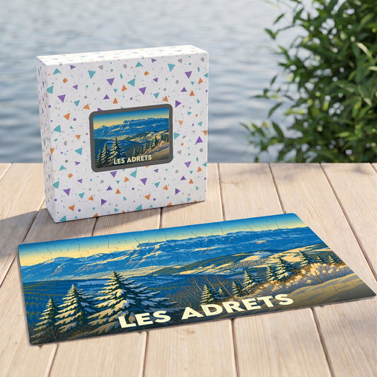 Puzzle souvenir de la ville de Les Adrets avec une illustration de paysage montagneux enneigé.
