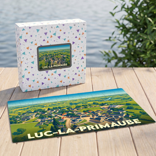 Puzzle souvenir de la ville de Luc-la-Primaube avec une illustration stylisée d'une vue aérienne.