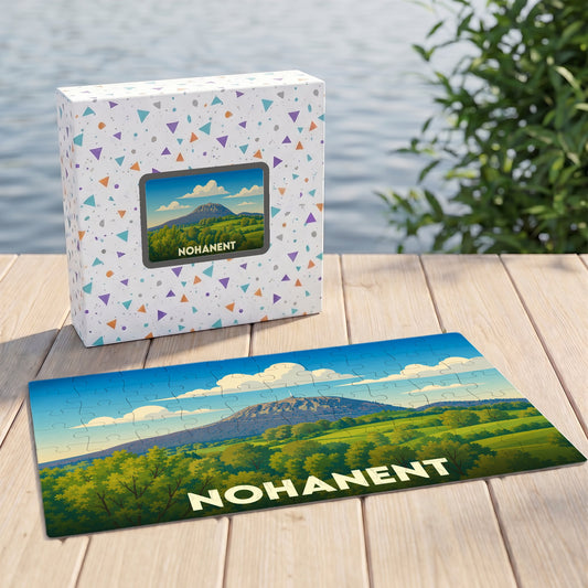 Puzzle souvenir de la ville de Nohanent avec une illustration stylisée d'un paysage de montagne.