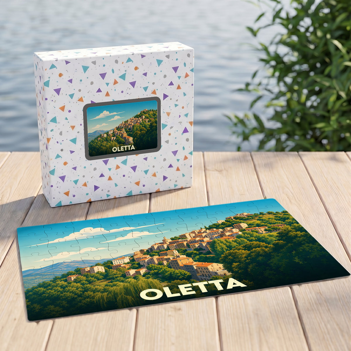 Puzzle souvenir de la ville d'Oletta représentant un village perché dans un paysage verdoyant.