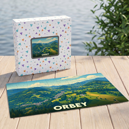 Puzzle souvenir de la ville d'Orbey avec une illustration panoramique de ses paysages verdoyants.