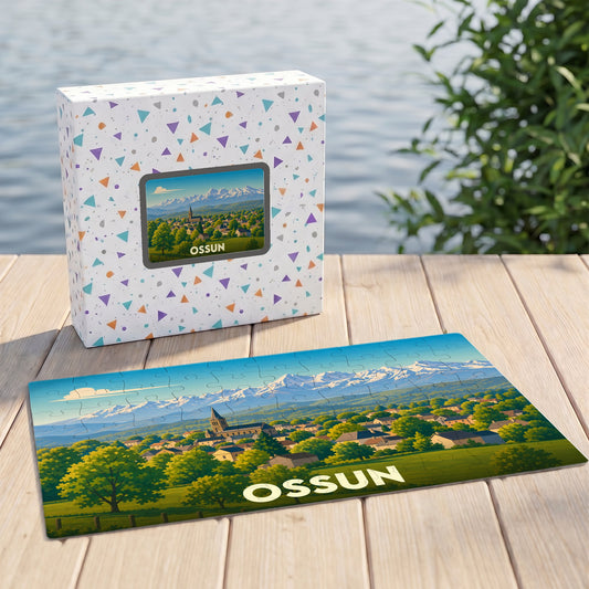 Puzzle souvenir de la ville d'Ossun illustrant un paysage de village devant une chaîne de montagnes enneigées.