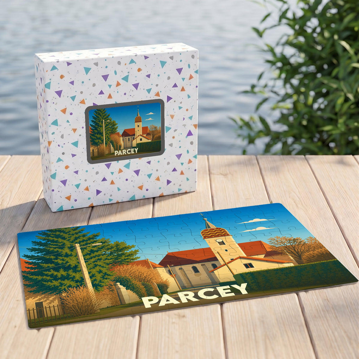 Puzzle souvenir de la ville de Parcey avec une illustration stylisée d'une église et son emballage assorti.