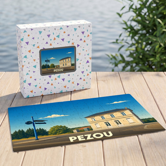 Puzzle souvenir de la ville de Pezou avec une illustration stylisée d'un bâtiment et sa boîte assortie.