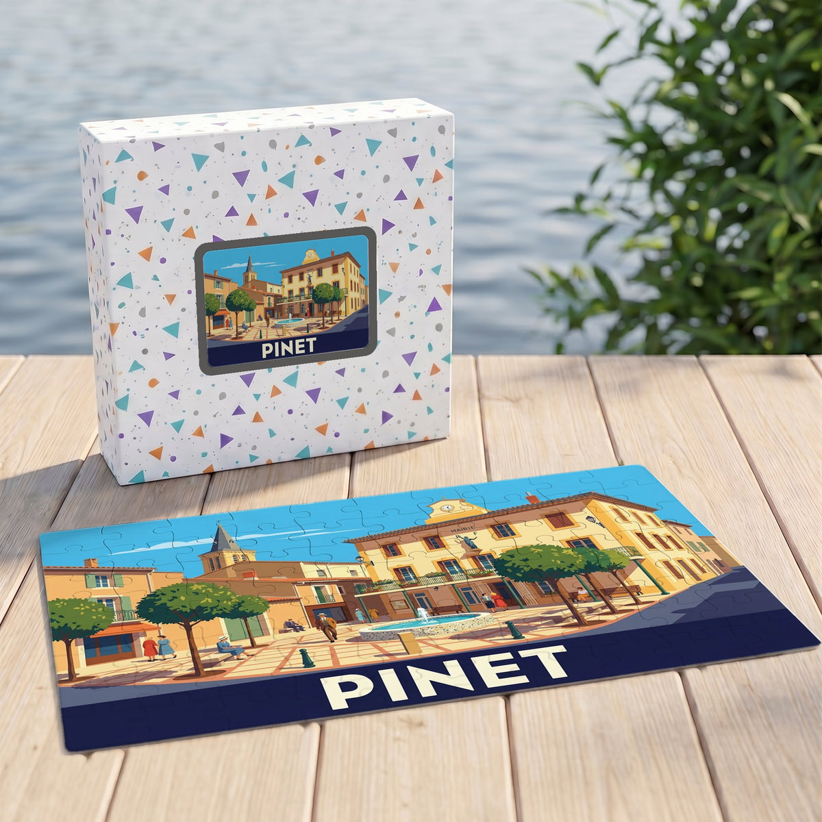 Puzzle souvenir de la ville de Pinet avec une illustration stylisée d'une place ensoleillée.