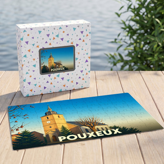 Puzzle souvenir de la ville de Pouxeux avec une illustration stylisée d'une église sur sa boîte assortie.