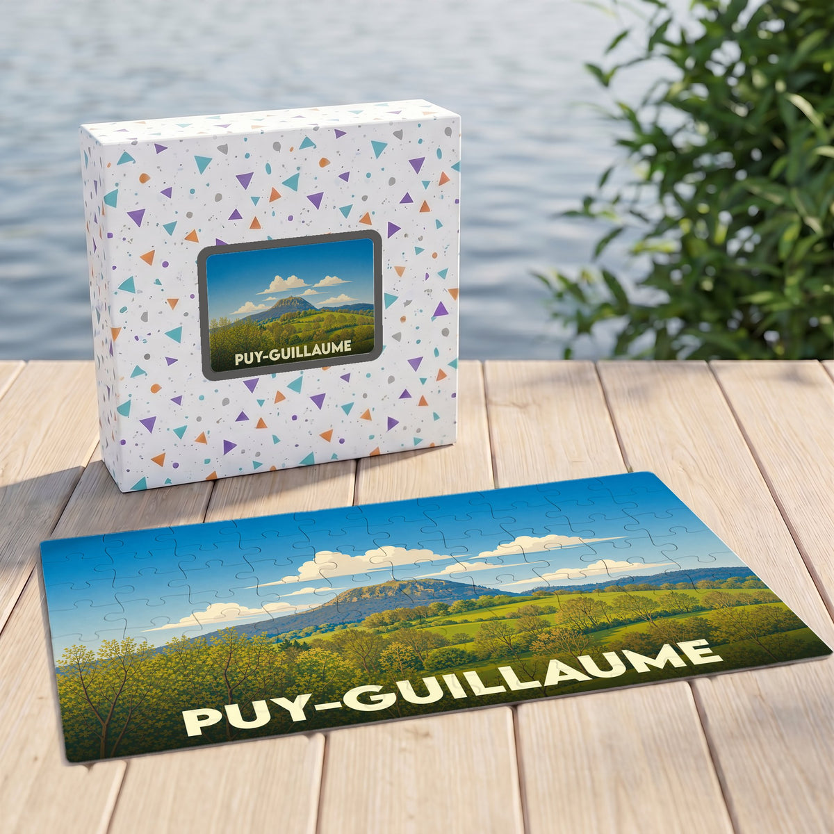 Puzzle souvenir de la ville de Puy-Guillaume illustré par un paysage vallonné sous un ciel bleu.