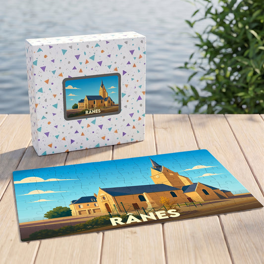 Puzzle souvenir de la ville de Rânes avec une illustration stylisée de son église et de ses bâtiments.