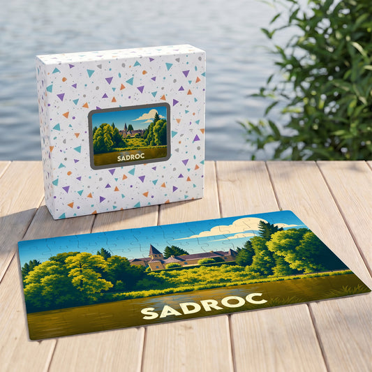 Puzzle souvenir de la ville de Sadroc avec son illustration stylisée de paysage et sa boîte assortie.