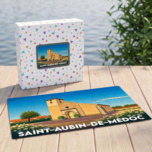 Puzzle souvenir de la ville de Saint-Aubin-de-Médoc avec son coffret assorti, illustrant l'église locale dans un style épuré.