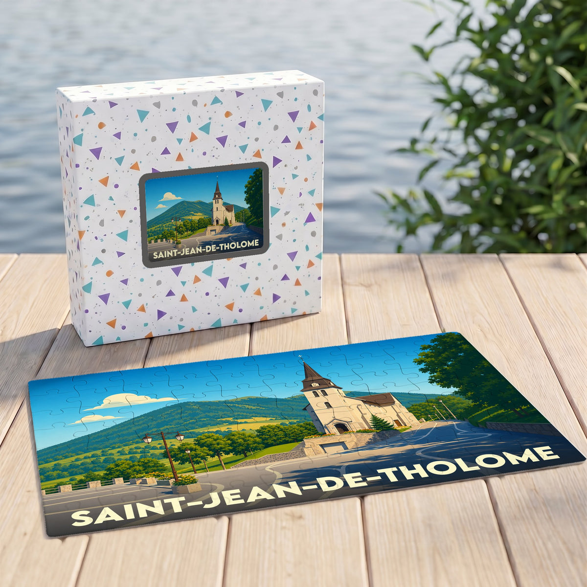 Puzzle souvenir de la commune de Saint-Jean-de-Tholome illustré par un paysage de montagne et son église.