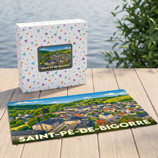 Puzzle souvenir de la ville de Saint-Pé-de-Bigorre avec une illustration paysagère stylisée, présenté devant sa boîte.