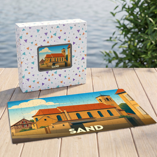 Puzzle souvenir de la ville de Sand présentant une illustration stylisée d'une église locale.