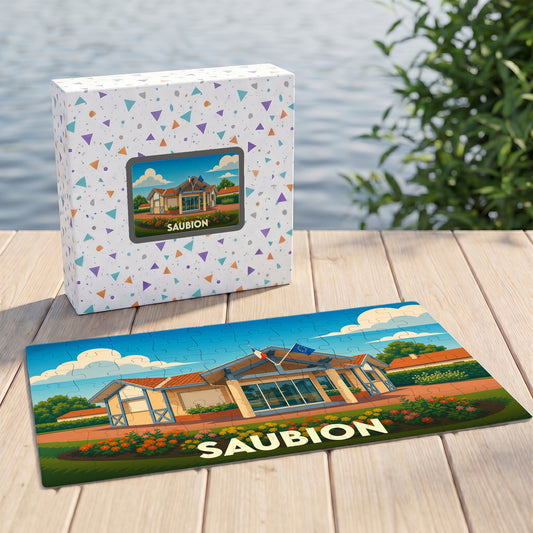 Puzzle souvenir de la ville de Saubion avec une illustration stylisée d'un bâtiment sous un ciel bleu.