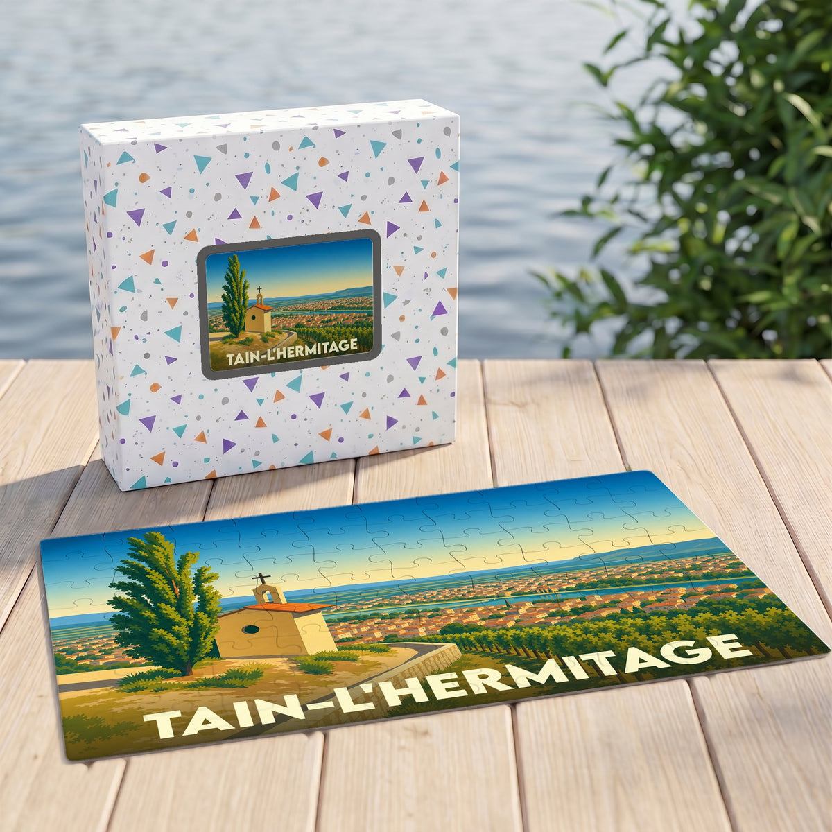 Puzzle souvenir de la ville de Tain-l'Hermitage avec une illustration stylisée et colorée.