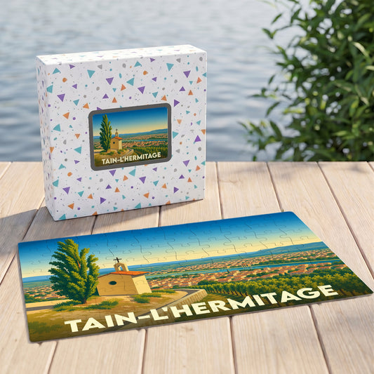 Puzzle souvenir de la ville de Tain-l'Hermitage avec une illustration stylisée et colorée.