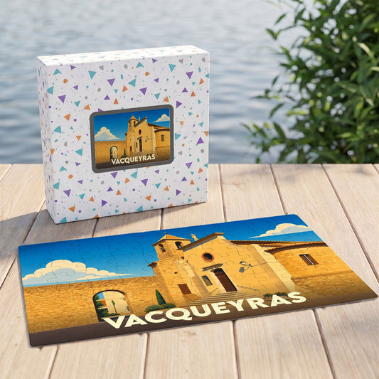 Puzzle souvenir de la ville de Vacqueyras avec une illustration stylisée et sa boîte assortie.