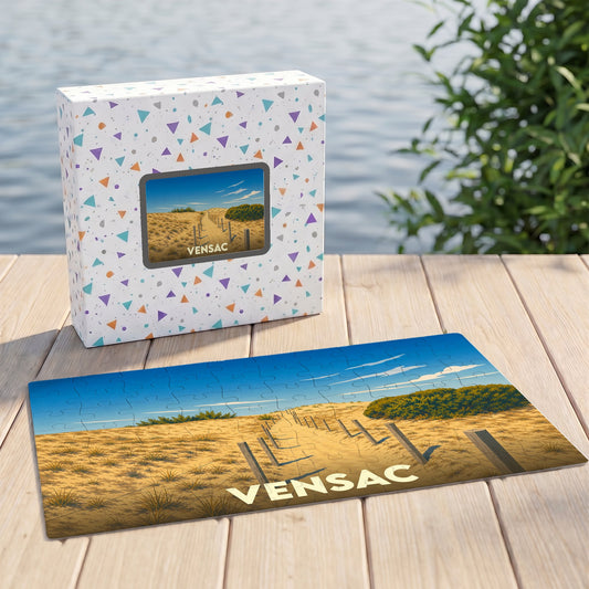 Puzzle souvenir de la ville de Vensac illustrant un chemin de sable vers les dunes.