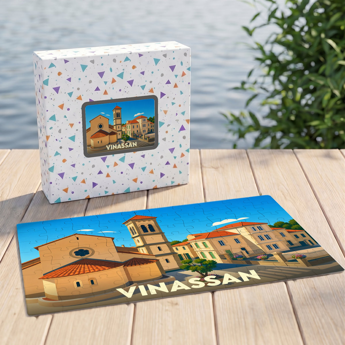 Puzzle souvenir de la ville de Vinassan illustré d'un paysage urbain stylisé, présenté avec sa boîte assortie.