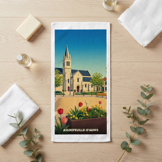 Serviette de bain souvenir de la ville d'Aigrefeuille-d'Aunis avec une illustration stylisée de son église.