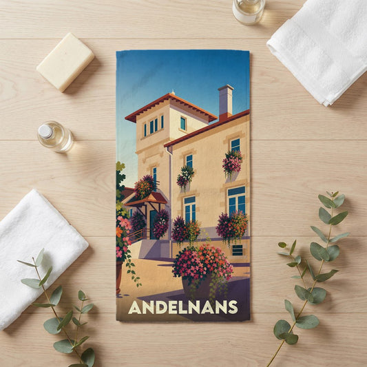 Serviette de bain souvenir de la ville de Andelnans avec une illustration stylisée d'un bâtiment fleuri.