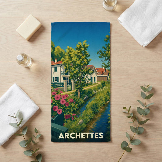 Serviette de bain souvenir de la ville d'Archettes avec une illustration stylisée de maisons et de paysages.