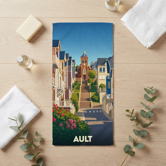 Serviette de bain souvenir de la ville d'Ault ornée d'une illustration stylisée de ses rues et de son église.