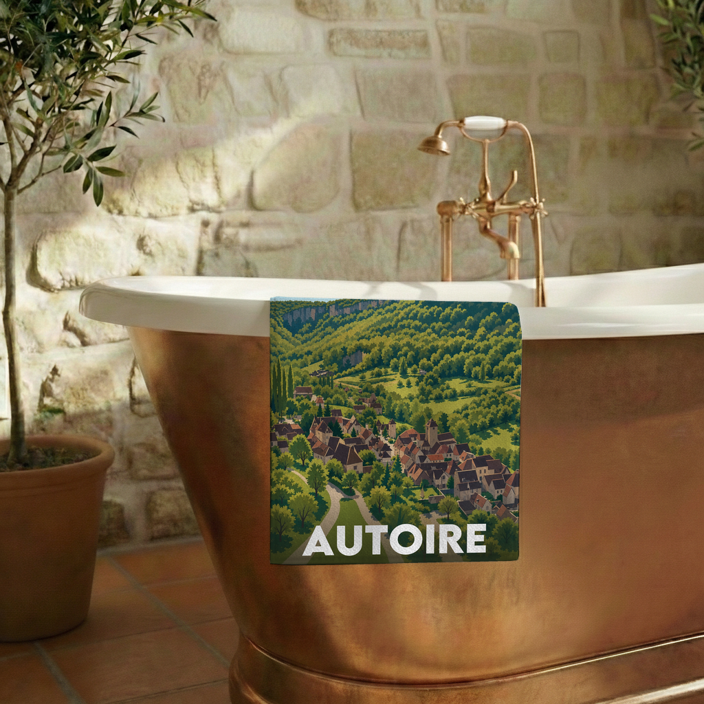 Serviette de bain souvenir de la ville d'Autoire avec une illustration panoramique stylisée.