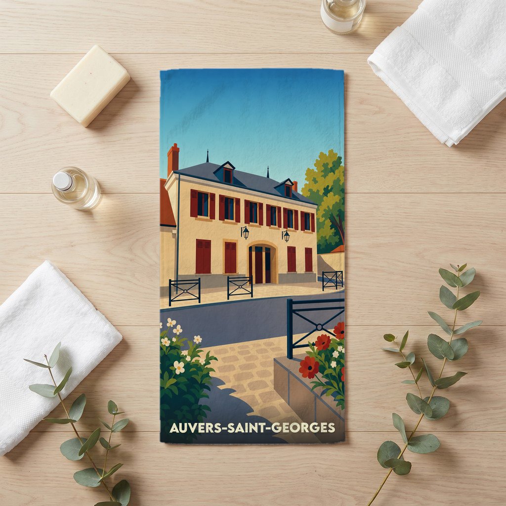 Serviette de bain souvenir de la ville de Auvers-Saint-Georges avec une illustration stylisée d'un bâtiment historique.