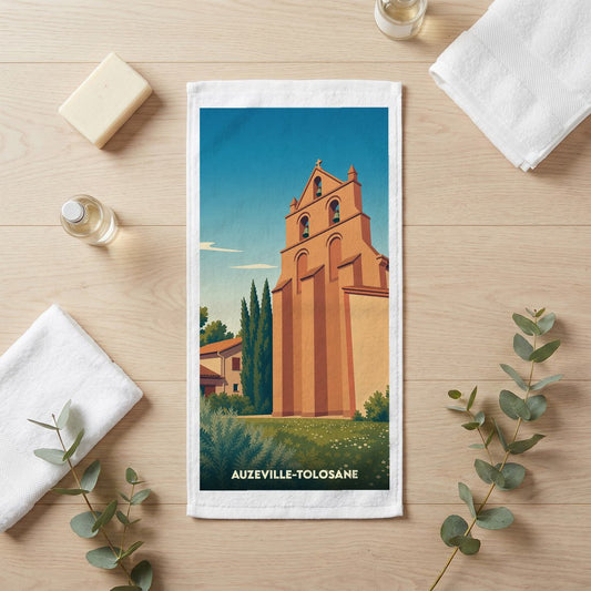 Serviette de bain souvenir de la ville d'Auzeville-Tolosane avec une illustration stylisée de son église.