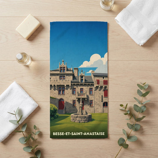Serviette de bain souvenir de la ville de Besse-et-Saint-Anastaise avec une illustration stylisée d'un château médiéval.