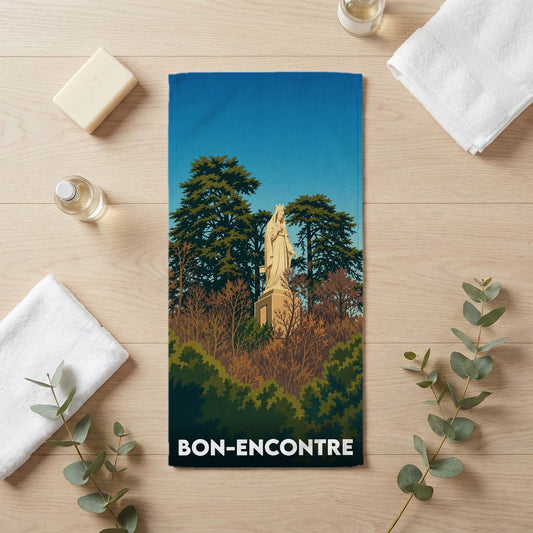Serviette de bain souvenir de la ville de Bon-Encontre avec une illustration stylisée d'une statue.