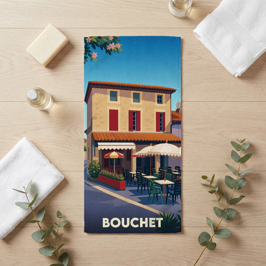 Serviette de bain souvenir de la ville de Bouchet avec une illustration stylisée d'une terrasse de café.
