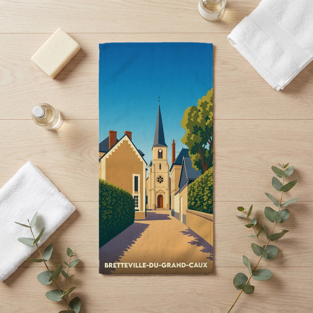 Serviette de bain souvenir de la ville de Bretteville-du-Grand-Caux avec une illustration stylisée du clocher et des maisons du village.