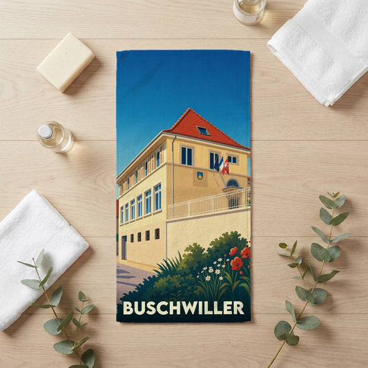 Serviette de bain souvenir de la ville de Buschwiller avec une illustration stylisée de la mairie.